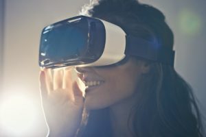 Woman with a VR headset smiling.