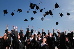 Happy graduates throw their caps in the air. 