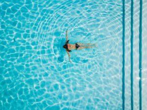 a woman swimming in a pool