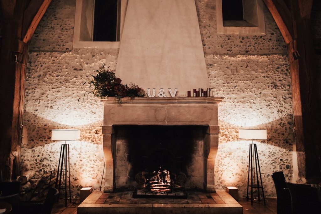 A cozy fireplace lit during the holidays.
